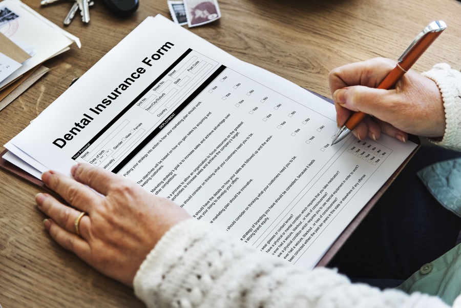 Patient completing a dental insurance form